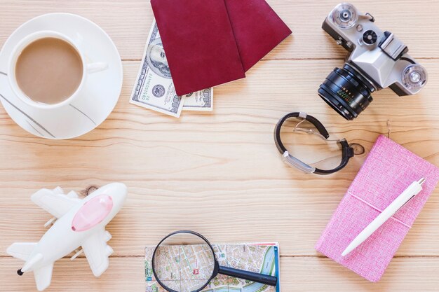 Various traveler accessories with tea cup on wooden background