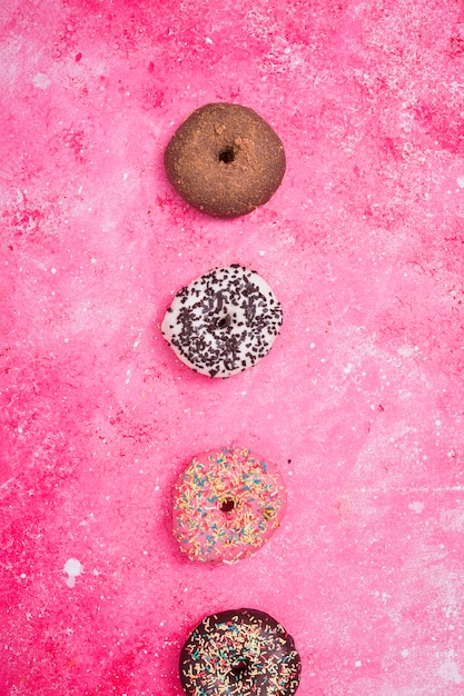 Free Photo various type of macaroons over the pink textured backdrop