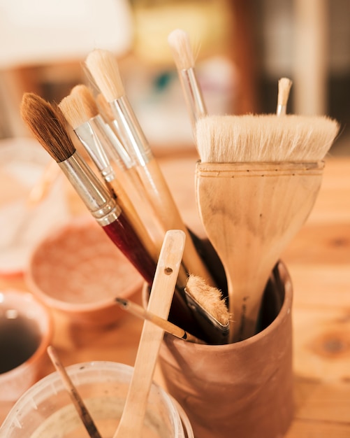 Various type of paint brushes in the clay holder