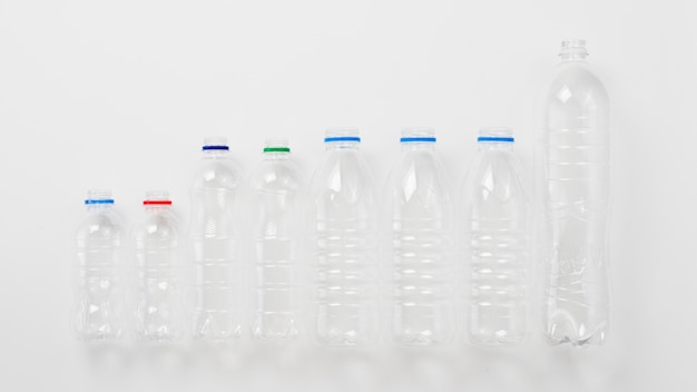 Free photo various types of plastic bottles on grey background