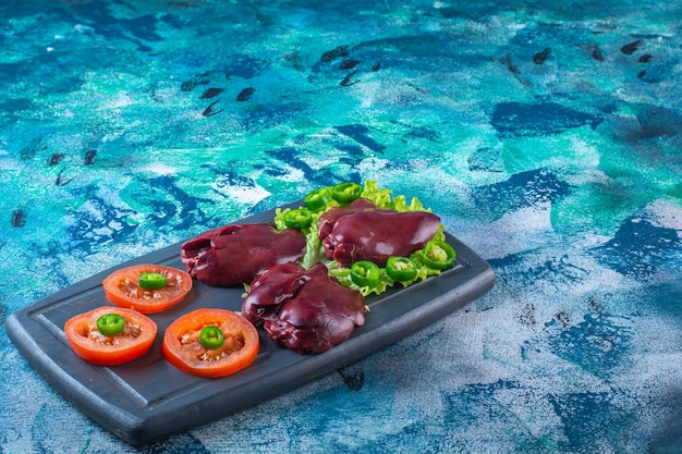 Free Photo various vegetables and chicken liver on the wooden tray