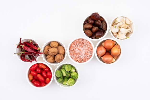 Various vegetables in white bowls