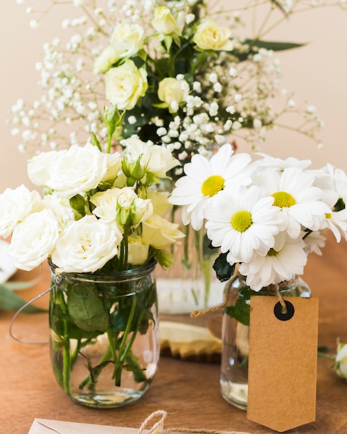 Vase with flowers on table