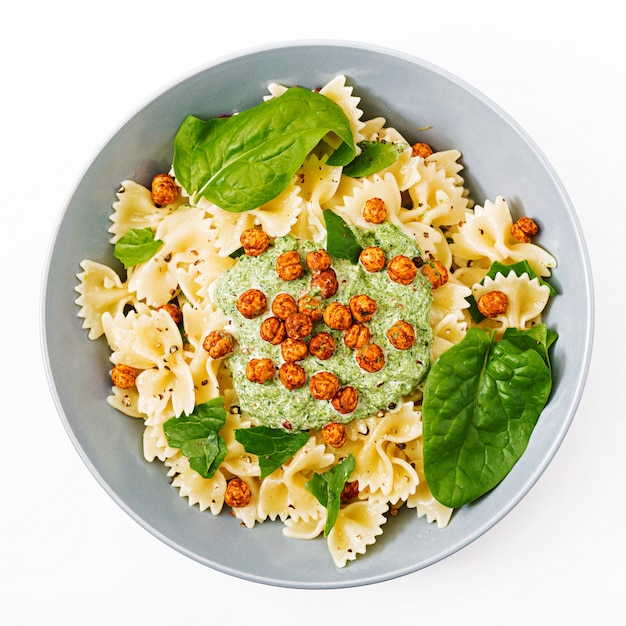 Vegan Farfalle pasta with spinach sauce with fried chickpeas.