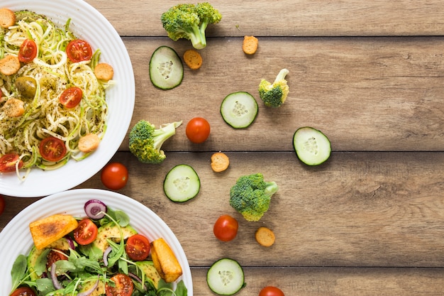 Free Photo vegan food on white plates with wooden background