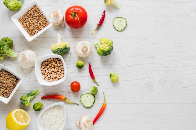 Vegan food on white wooden table with copy space