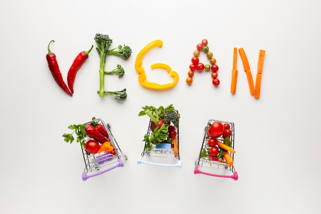 Free Photo vegan lettering with tiny shopping carts