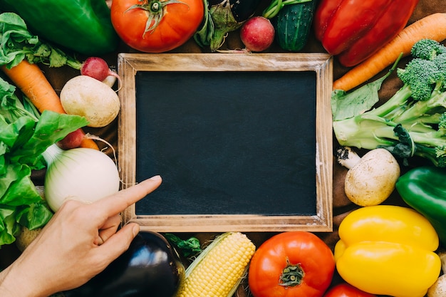 Vegetable decoration with hand pointing towards slate