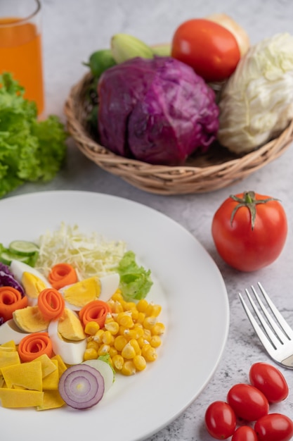 Vegetable and fruit salad on a white plate.