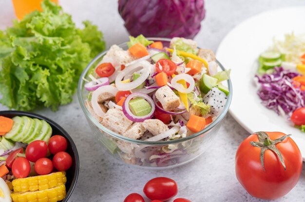 Vegetable and fruit salad on a white plate.