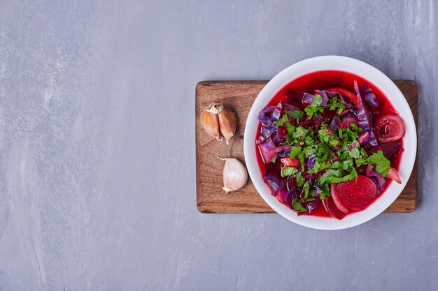 Vegetable salad in red sauce on blue