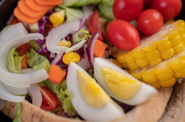 Vegetable salad with boiled eggs in a white dish.