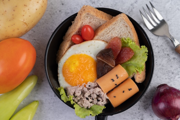 Vegetable salad with bread and boiled eggs in the pan.