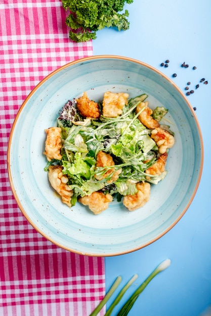 Vegetable salad with fried nuggets _