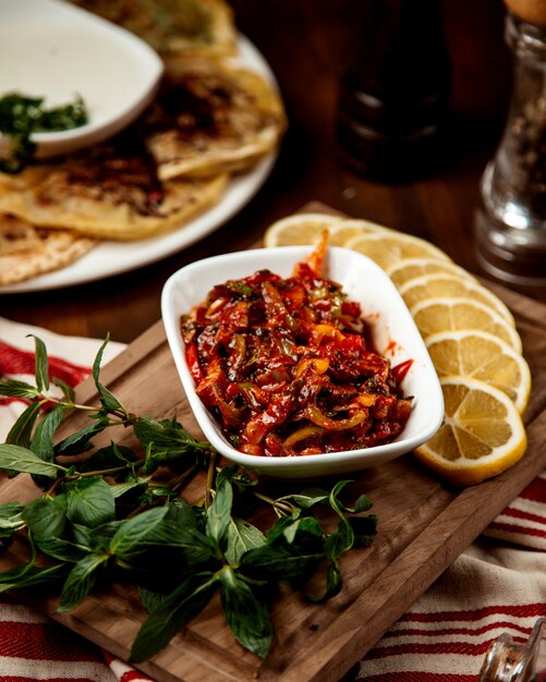 Vegetable salad with ketchup and lemon slices