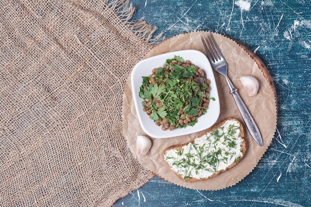 Vegetable salad with a slice of toast.