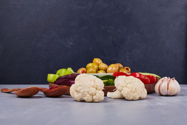 Vegetable salad with sliced and chopped foods and marinated olives.