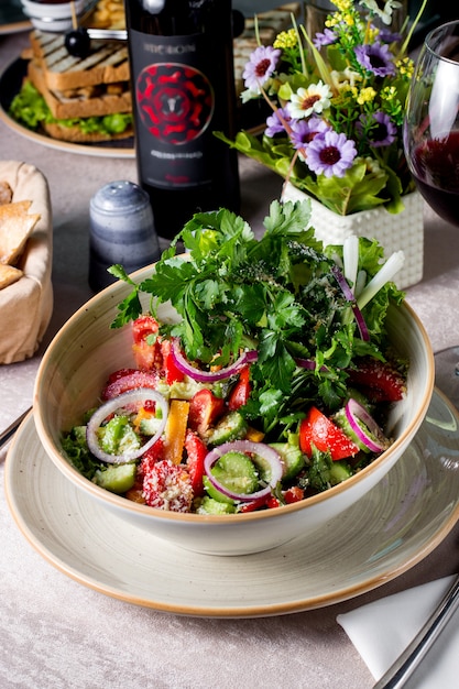 Vegetable salad with tomato cucumber bell peppers red onion grated parmesan and parsley