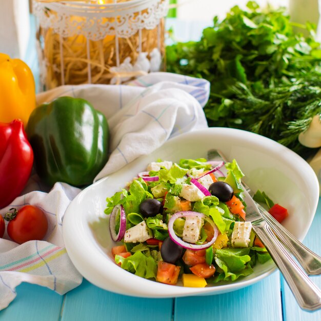 Vegetable salad with tomato, lettuce, red onion, bell pepper, olive and cheese