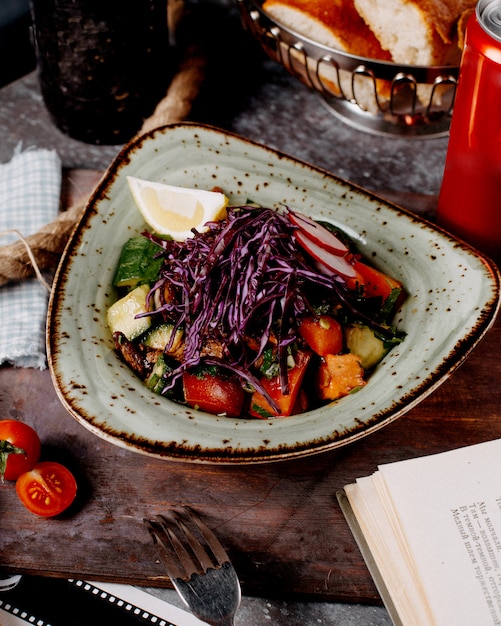 Free Photo vegetable salad with tomatoes, cucumbers, radishes, cabbage and slice of lemon