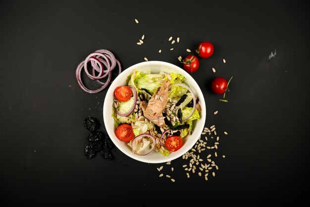 Free photo vegetable salad with tuna and side onion slices top view