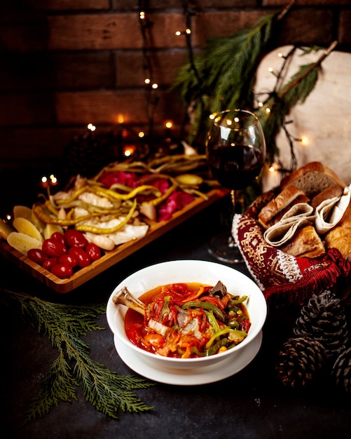 Vegetable soup with pickles and glass of wine