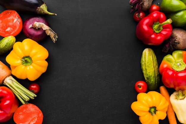 Vegetables arrangement on dark background with copy space