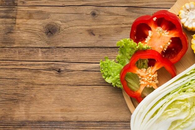 Vegetables composition on wooden background with copy space