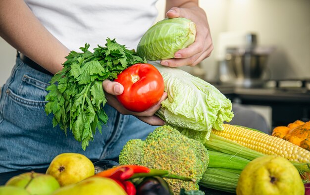 Vegetables in female hands the concept of food preparation in the kitchen