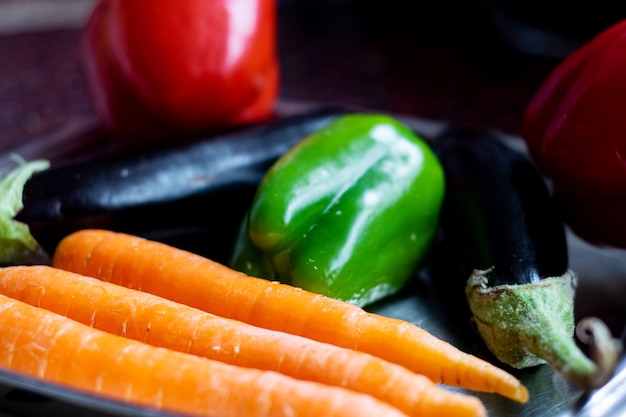 Vegetables fresh ripe vegetables such as orange carrots black eggplant and green bell pepper