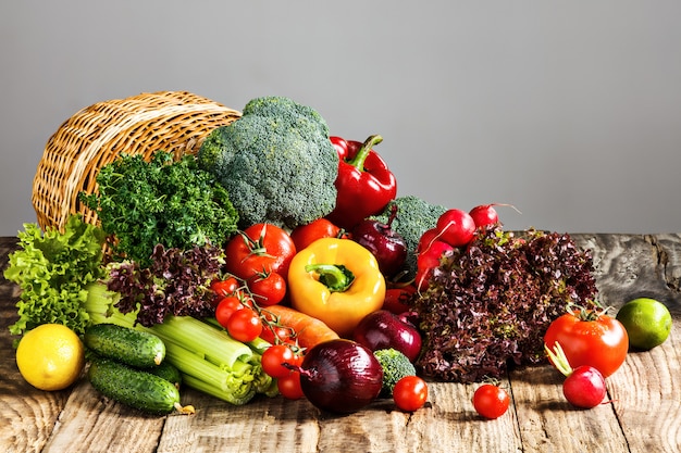 The vegetables from a  basket on wooden table