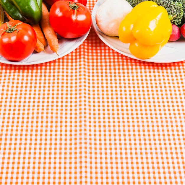 Vegetables on plates with space on bottom