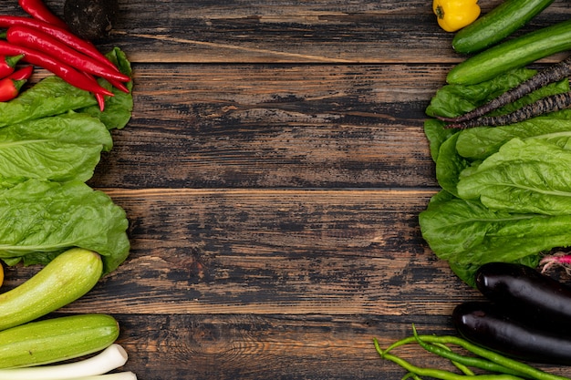 vegetables on right and left sides of the frame on a wooden table