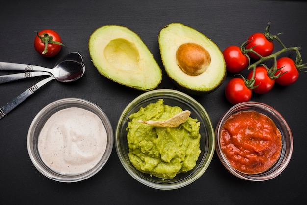 Free Photo vegetables and set of sauces in bowls near spoons