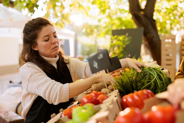 Free photo vendor checking quality of organic items