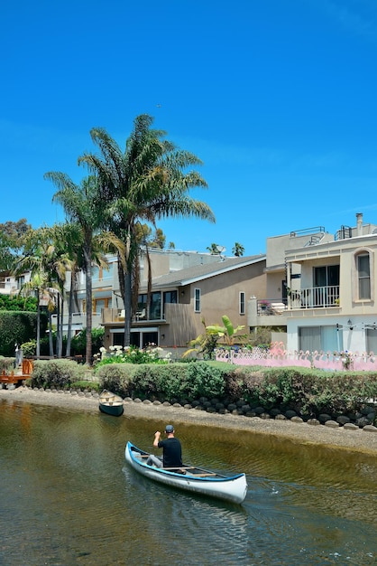 Venice Canals Walkway with river and boat in Los Angeles, California.