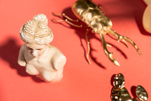 Venus bust next to golden scarab