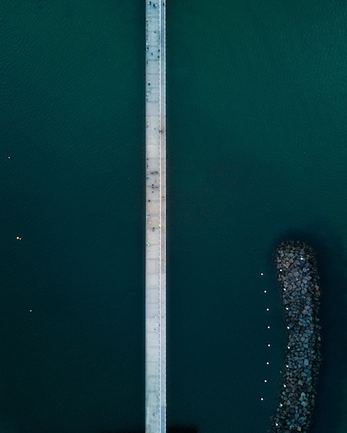 Free Photo a vertical aerial shot of a narrow bridge