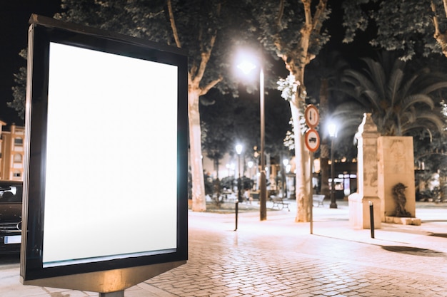 Free photo vertical blank billboard on street at night