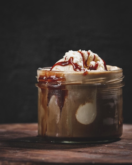 Vertical closeup of ice cream in a small glass jar