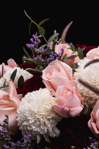 Vertical closeup  of a luxurious bouquet of pink roses and white flowers 