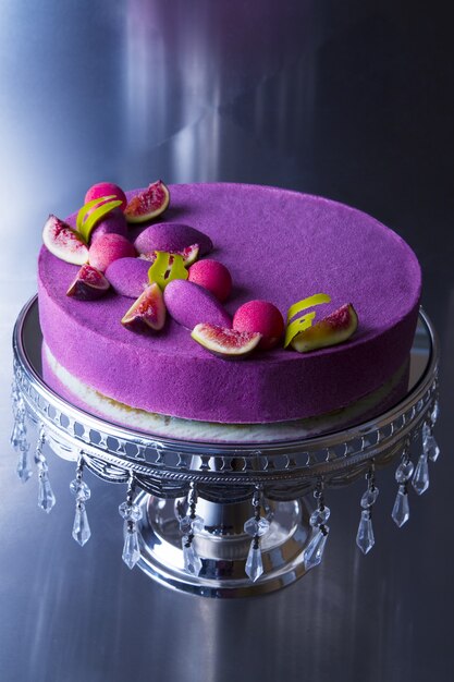 Vertical closeup shot of a beautiful purple cake with figs