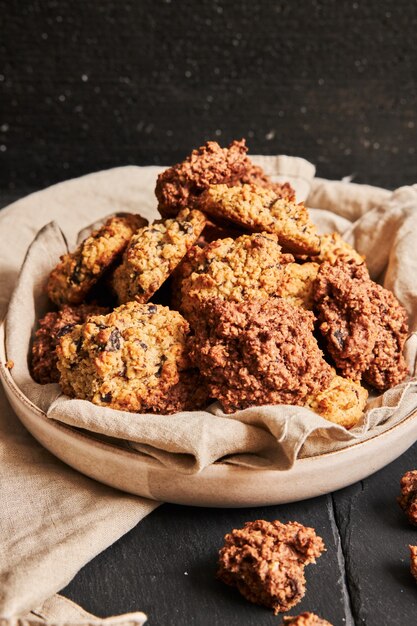 Vertical closeup shot of delicious homemade oatmeal cookies in a plate