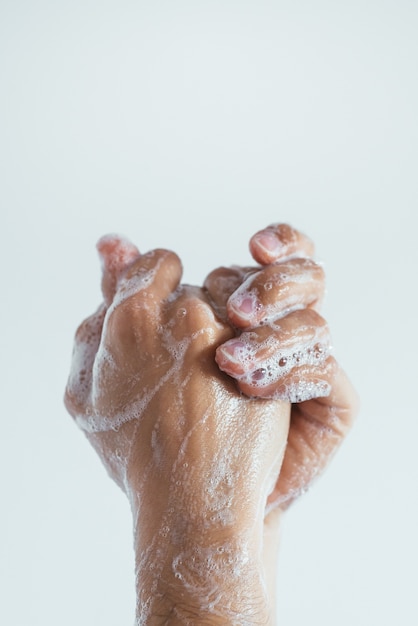 Free photo vertical closeup shot of the soaped hands of a person