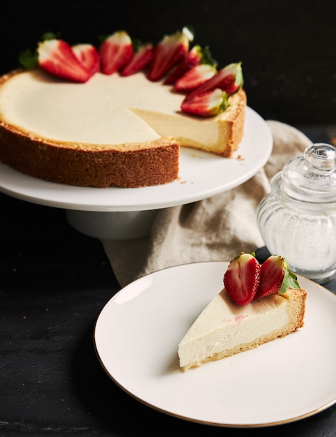 Vertical closeup shot of Strawberry Cheesecake on a white plate