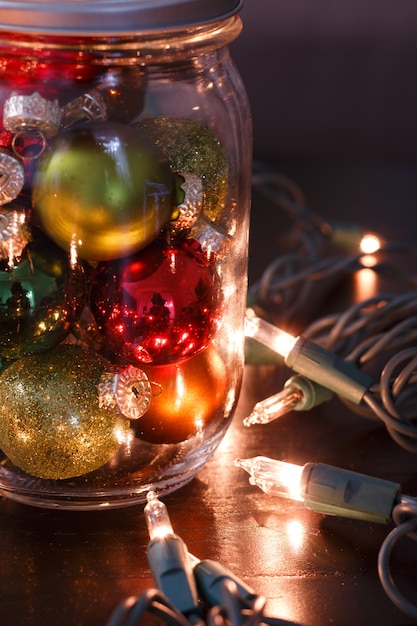 Free photo vertical closeup view of colorful small baubles inside the glass jar