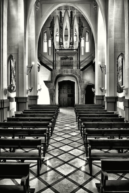 Free photo vertical grayscale shot of the interior of an old historical christian church