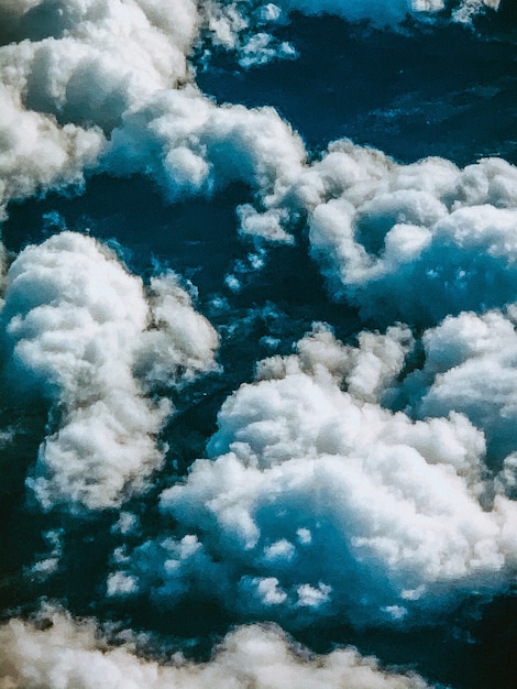 Free photo vertical high angle shot of the breathtaking clouds in the sky captured from above