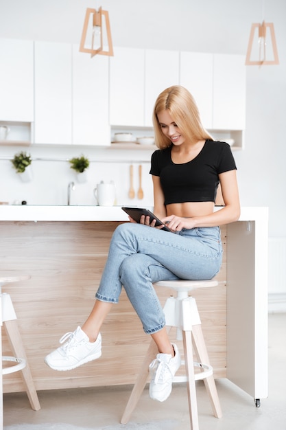 Vertical image of woman using tablet computer