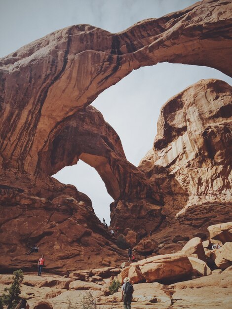 Vertical low angle shot of the double arch at arches national park on a sunny day